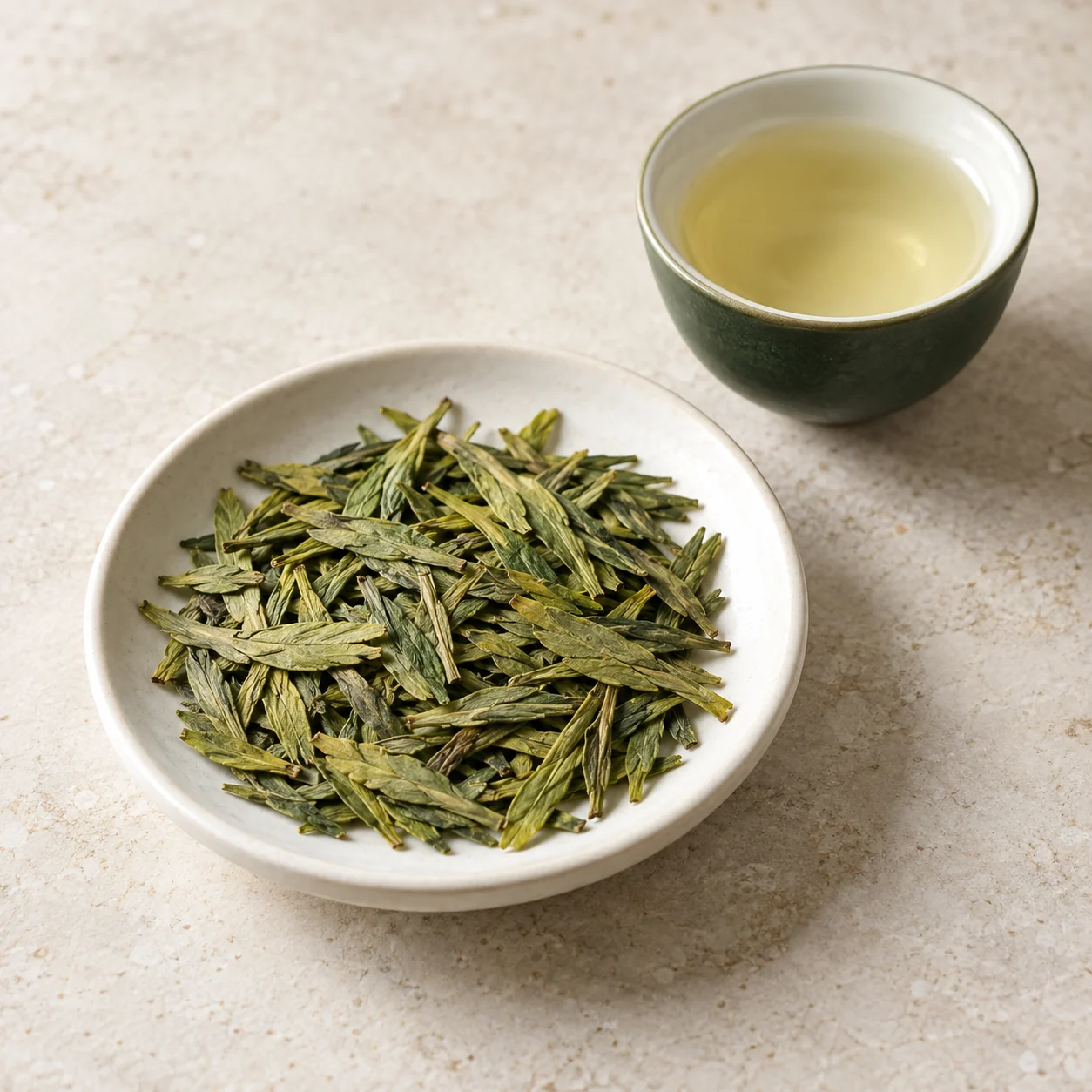 Ingredient illustration of flat green Longjing leaves and a pale green infusion; not a product photograph